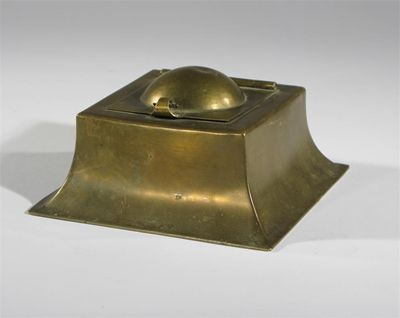 Appraisal: A brass inkwell with hinged cover designed by C F