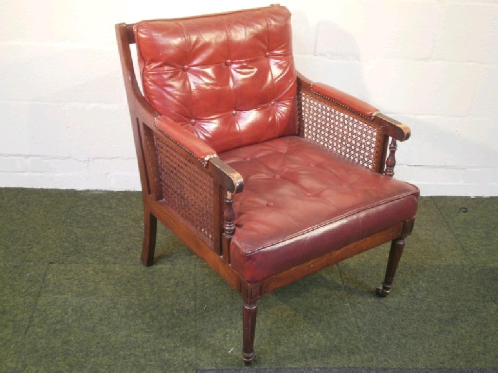 Appraisal: A Victorian mahogany style library chair with Bergere framing and