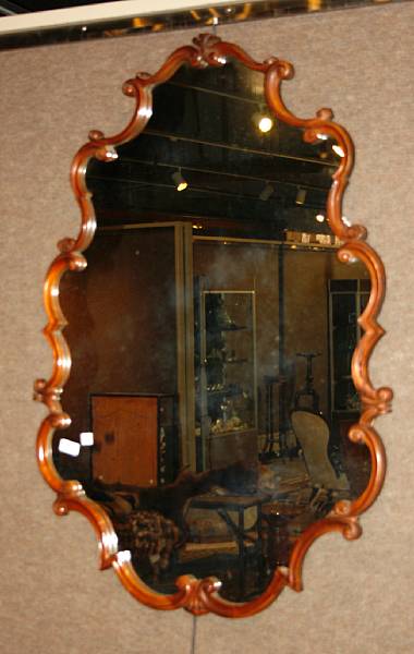 Appraisal: A Rococo style carved walnut mirror