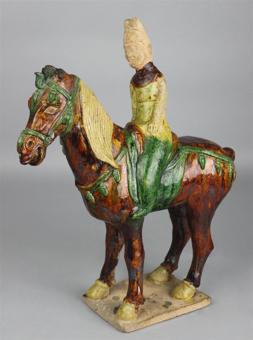 Appraisal: CHINESE SANCAI-GLAZED POTTERY MODEL OF A HORSE AND RIDER potted