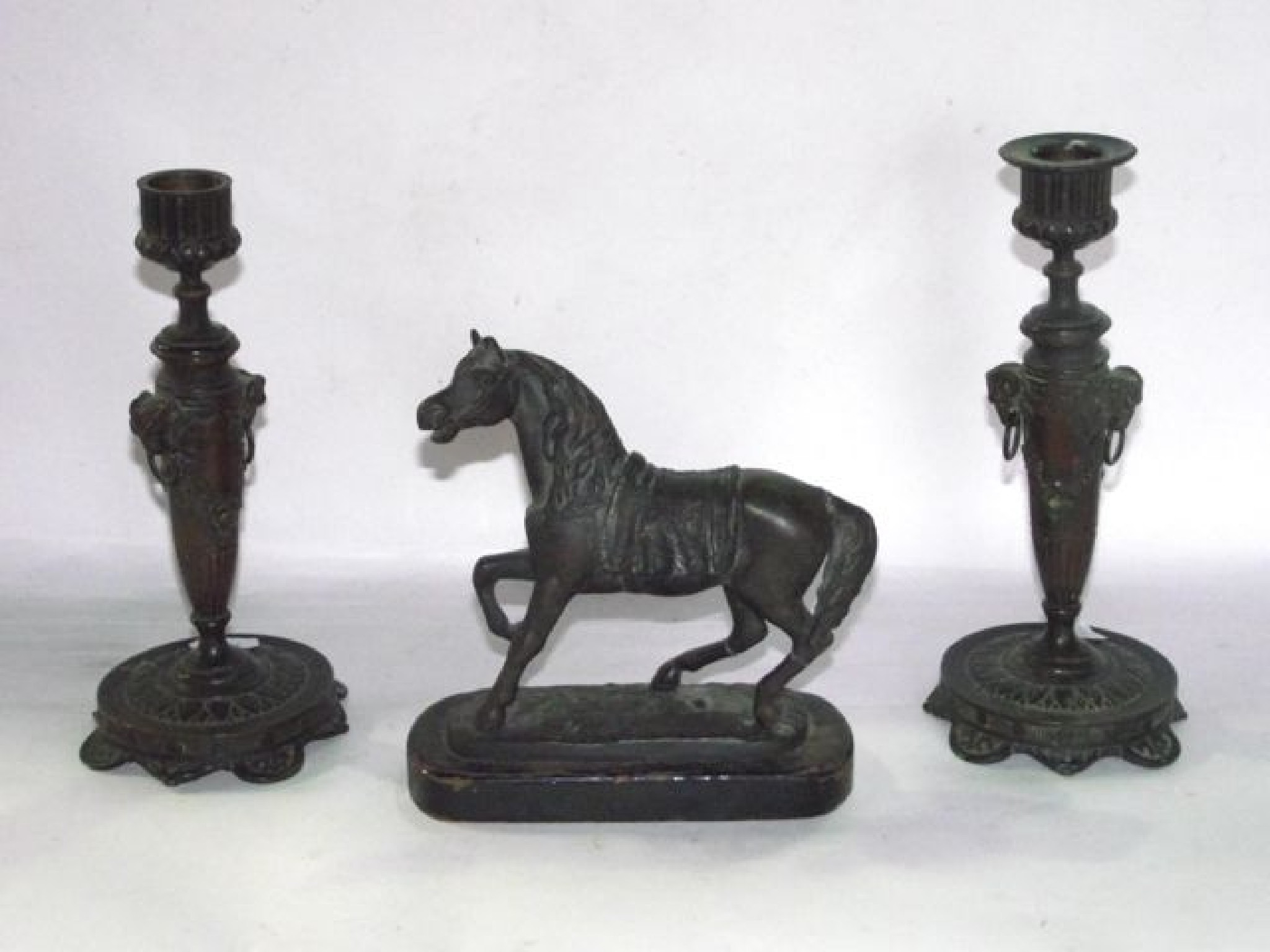 Appraisal: A pair of cast bronze candlesticks of tapering cylindrical form