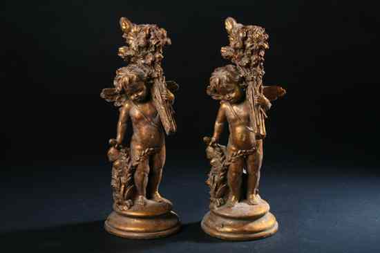 Appraisal: PAIR GILT COMPOSITION FIGURAL CANDLESTICKS th century Modelled as putto