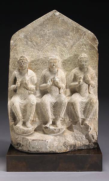 Appraisal: A carved limestone Buddhist stele Tang Dynasty Depicting three Buddhas