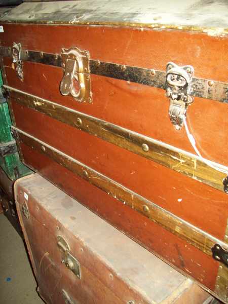 Appraisal: A METAL AND WOODEN BOUND DOMED TOP TRAVELLING TRUNK AND