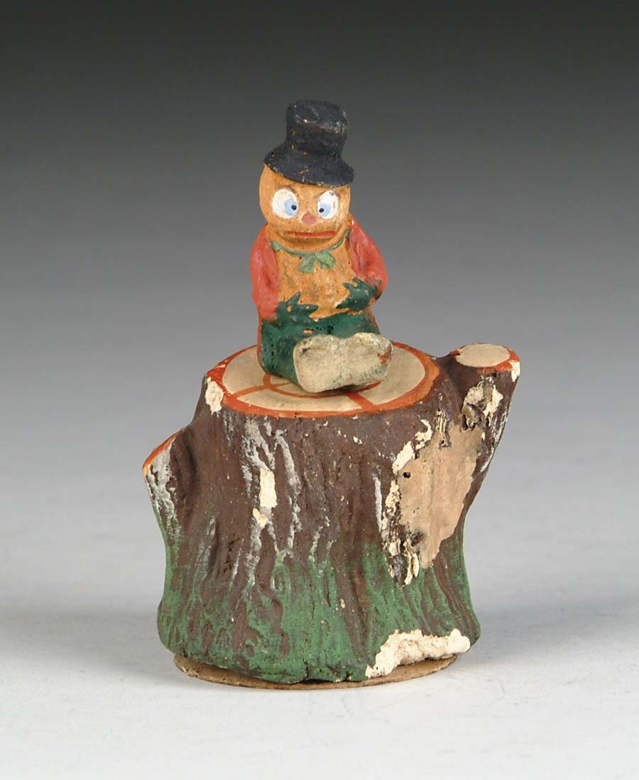 Appraisal: COMICAL VEGGIE MAN ATOP TREE TRUNK A top-hatted veggie man