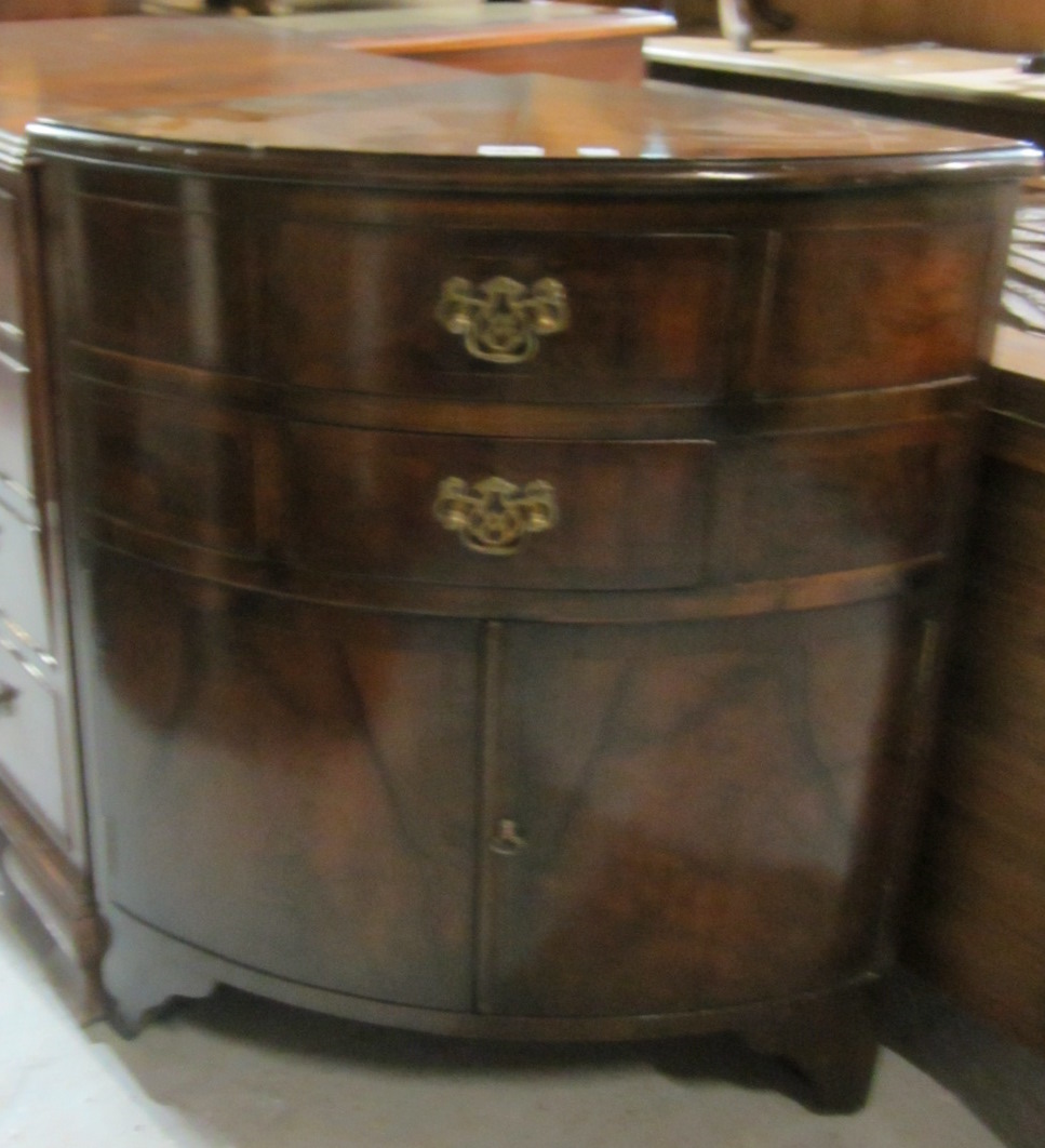 Appraisal: A th century mahogany bowfronted corner cupboard