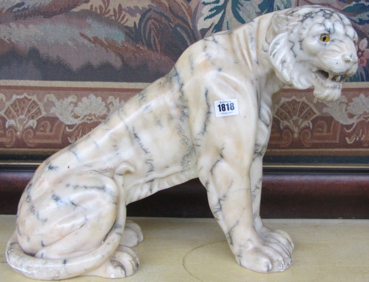 Appraisal: A polished alabaster tiger th century in a seated pose