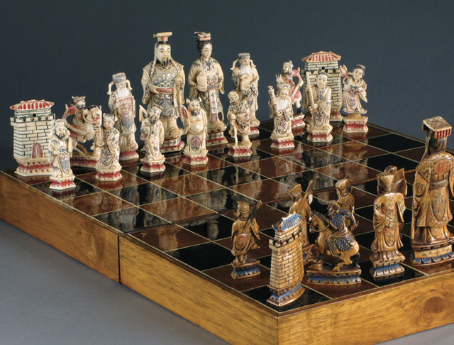 Appraisal: CHINESE HAND CARVED IVORY CHESS SET complete with thirty-two pieces