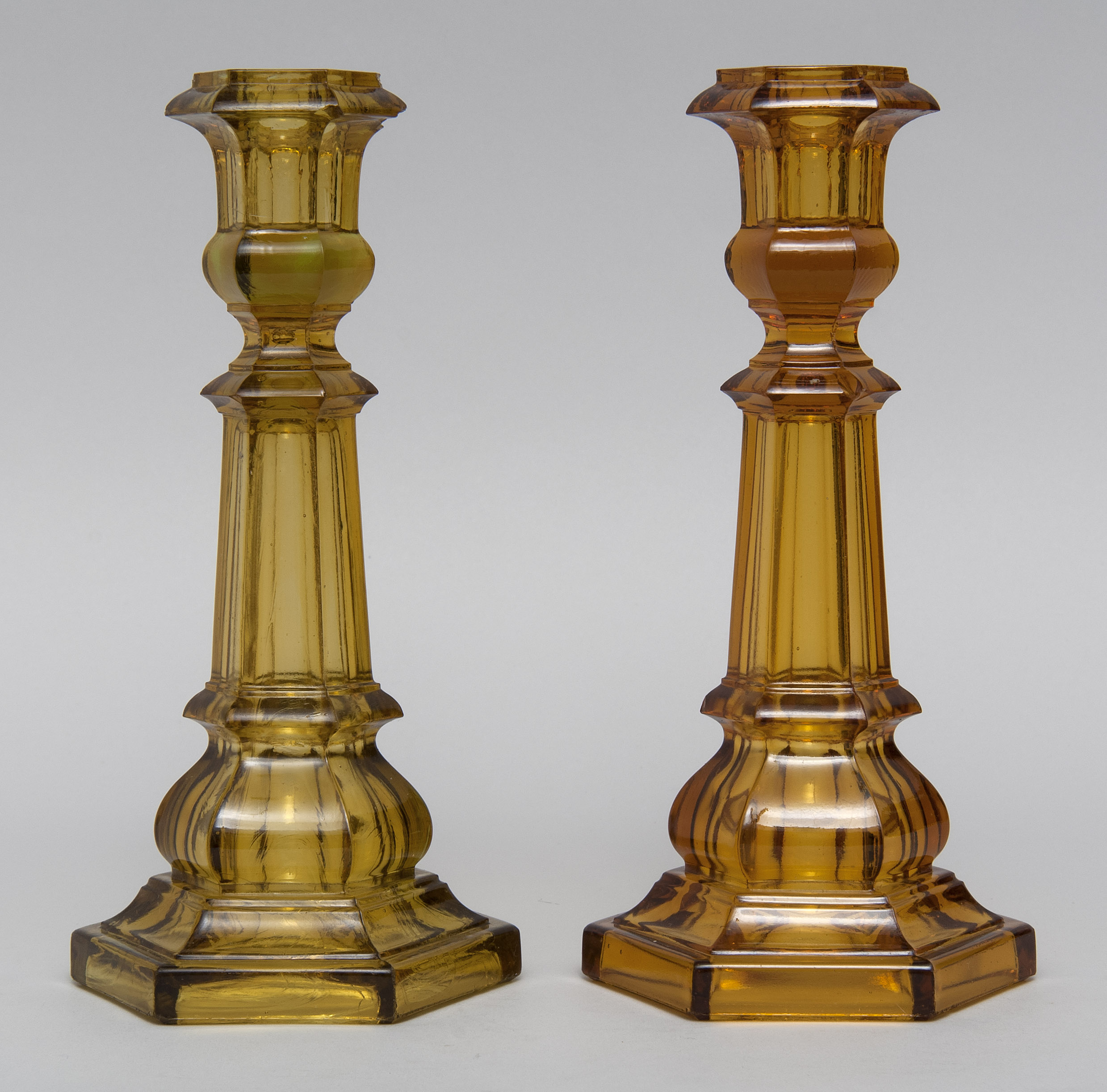 Appraisal: TWO PRESSED GLASS CANDLESTICKS th CenturyBoth in amber one slightly