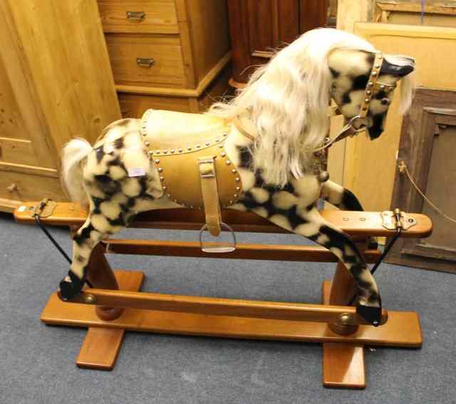 Appraisal: A REPRODUCTION VICTORIAN STYLE ROCKING HORSE with piebald decoration on