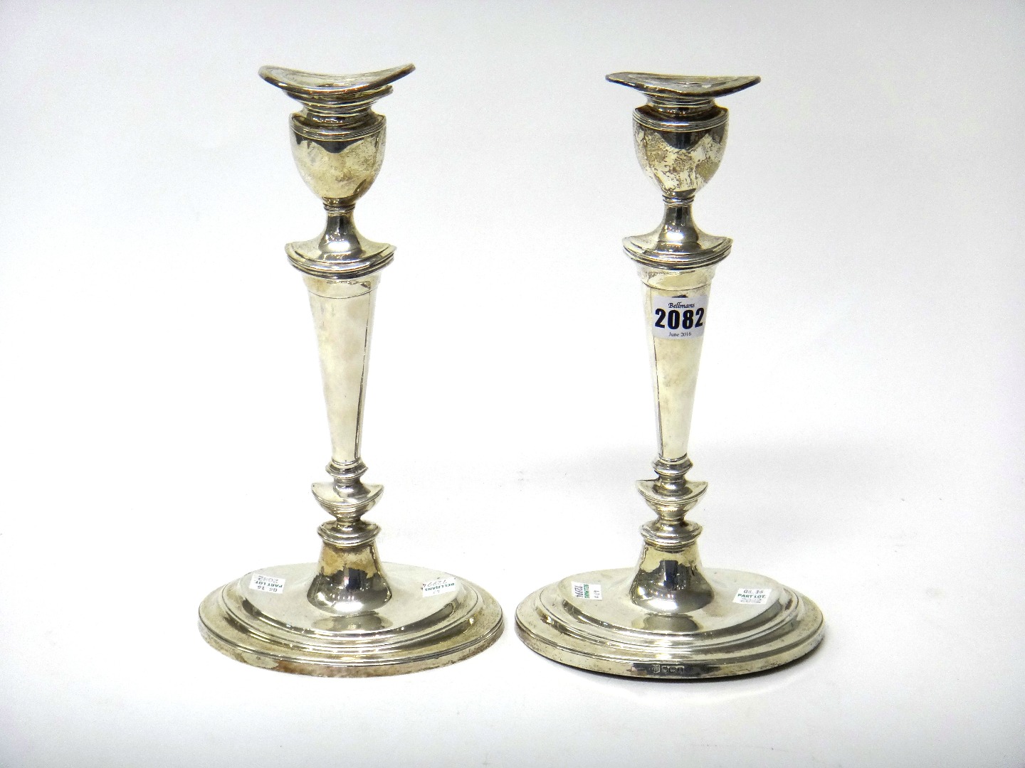 Appraisal: A pair of silver table candlesticks each with a tapering