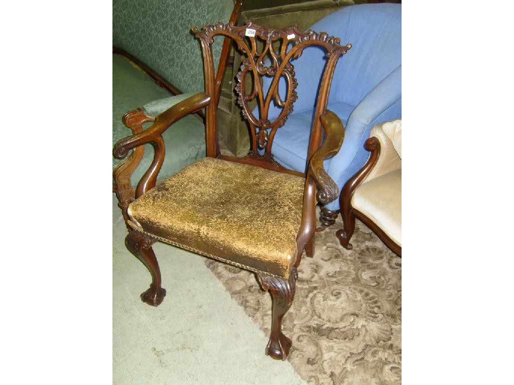 Appraisal: A th century mahogany elbow chair with carved and pierced