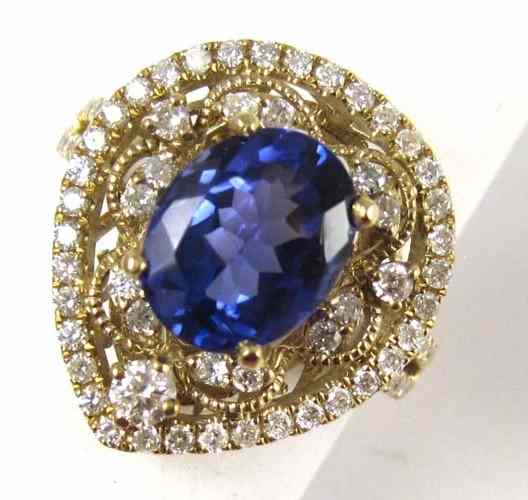 Appraisal: TANZANITE AND DIAMOND RING k yellow gold with round-cut diamonds