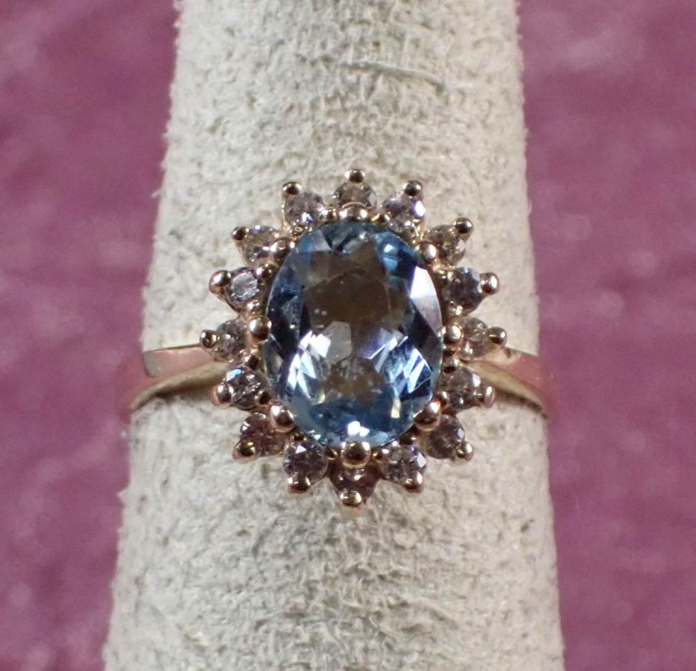 Appraisal: AQUAMARINE DIAMOND HALO AND FOURTEEN KARAT GOLD RING The yellow