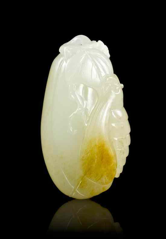 Appraisal: A Chinese Carved White Jade Toggle having yellow inclusions depicting