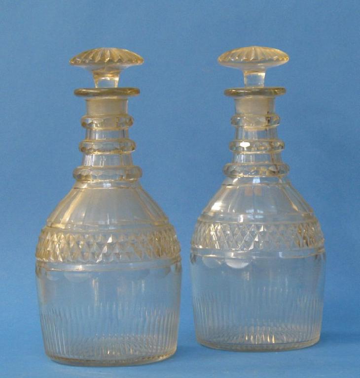 Appraisal: A PAIR OF REGENCY MALLET-SHAPED DECANTERS with mushroom-shaped stoppers ringed