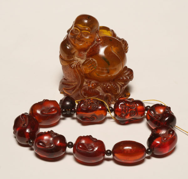 Appraisal: Chinese carved amber Buddha figure and prayer bead necklace Figure