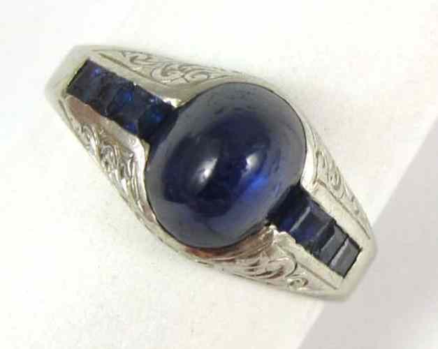 Appraisal: SAPPHIRE AND FOURTEEN KARAT WHITE GOLD RING with three table-cut