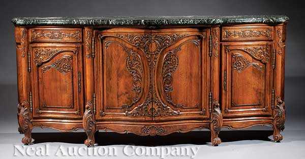 Appraisal: A Large French Carved Fruitwood Buffet serpentine marble top above