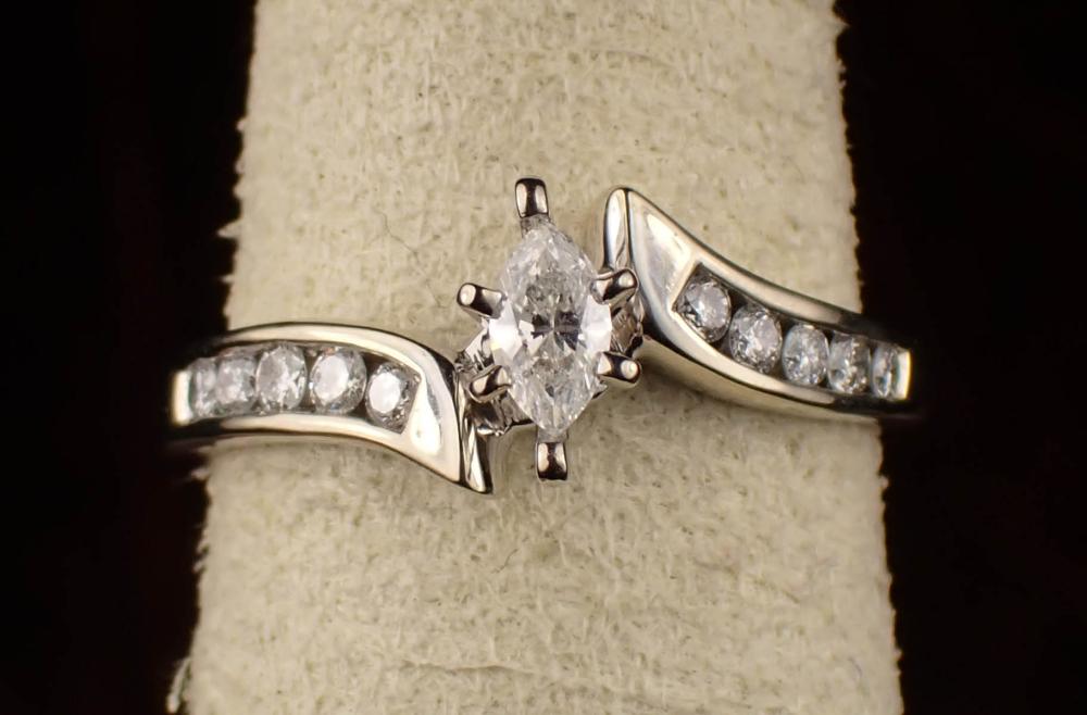 Appraisal: DIAMOND AND FOURTEEN KARAT WHITE GOLD RING with ten round-cut