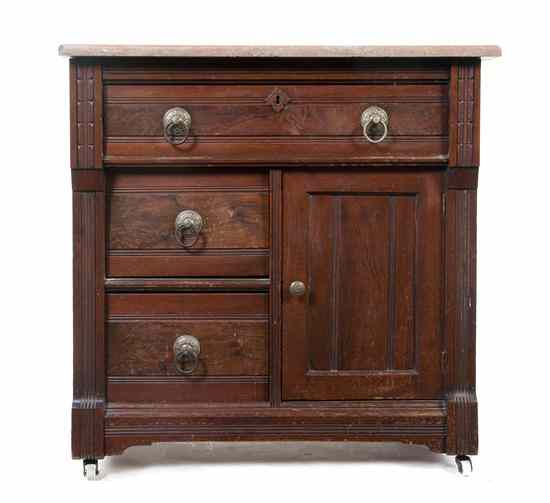 Appraisal: A Victorian Walnut Wash Stand having a rectangular marble top