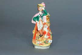 Appraisal: A Staffordshire figure of a hunter and dog cm