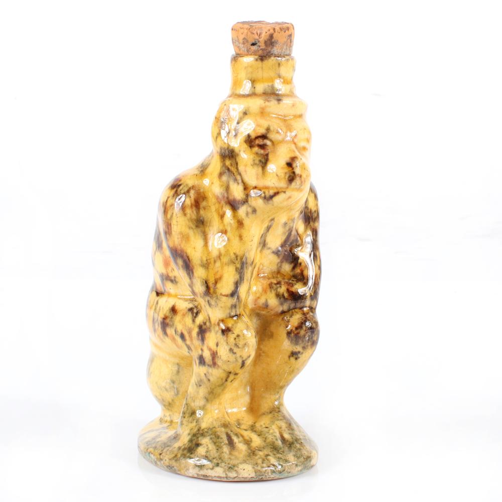 Appraisal: BENNINGTON ROCKINGHAM GLAZED FIGURAL POTTERY NOVELTY WHISKEY FLASK IN THE