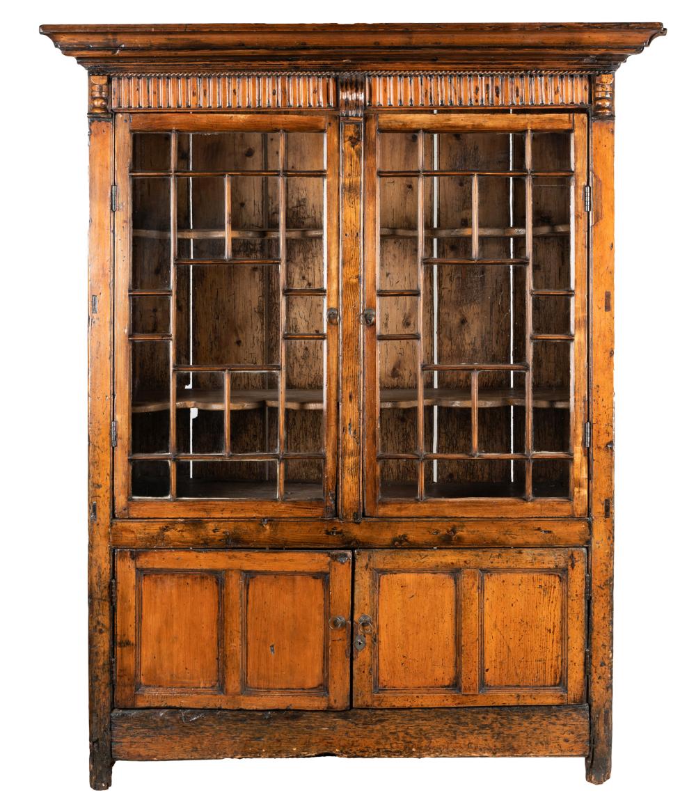 Appraisal: ANTIQUE STAINED PINE GLAZED CABINETthe hinged doors enclosing two serpentine