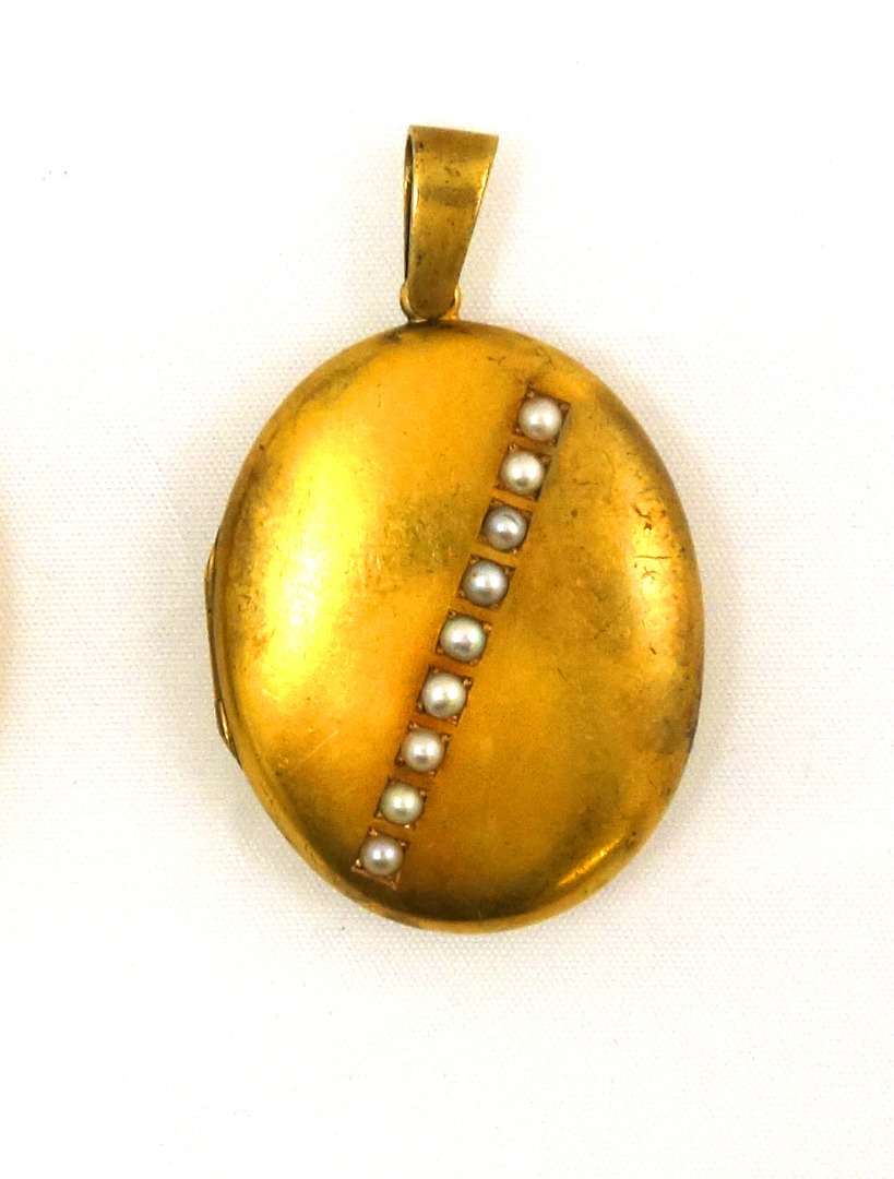 Appraisal: A late Victorian gold and half-pearl oval locket the front