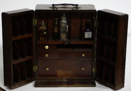 Appraisal: A th Century mahogany apothecary box with hinged doors concealing