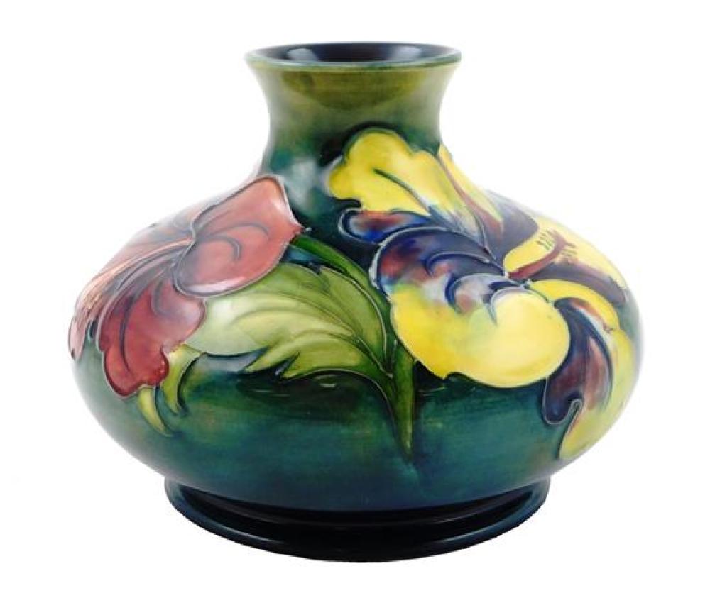 Appraisal: Moorcroft vase English decorated with red and yellow lillies Moorcroft