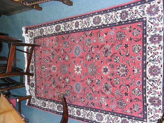 Appraisal: A NORTH WEST IRANIAN PINK GROUND RUG with railing foliate