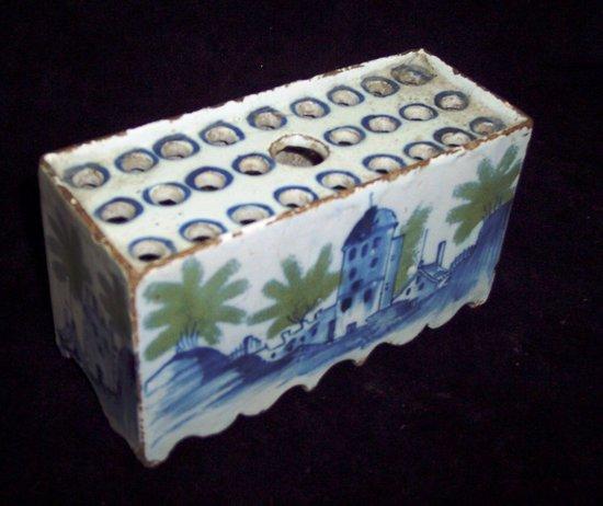 Appraisal: An th Century delftware flower brick painted buildings and shrubs