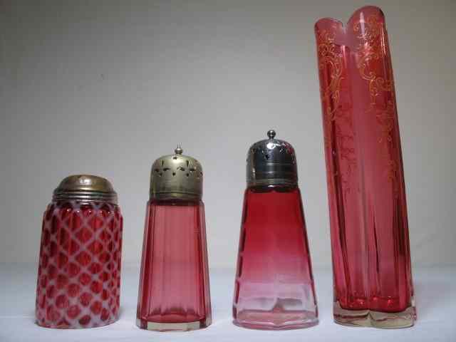 Appraisal: Cranberry glass group consisting of three muffineers sugar shakers in