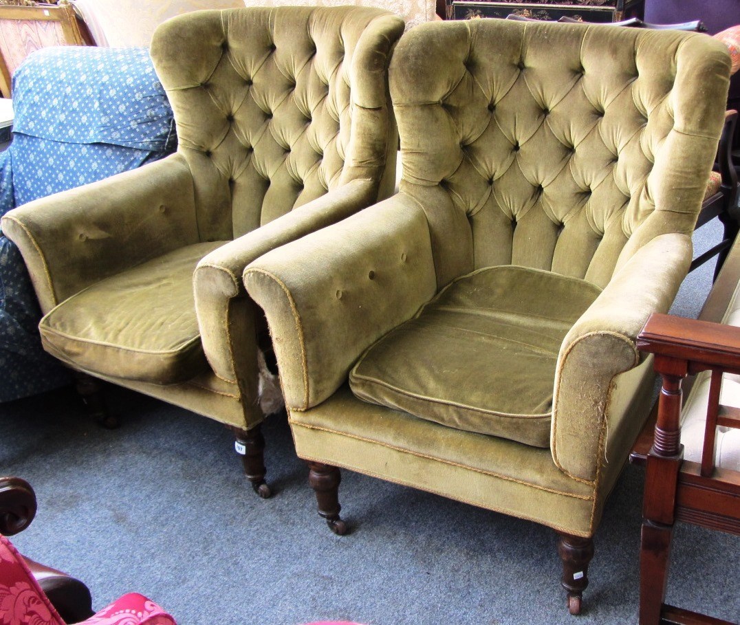 Appraisal: A pair of tub back armchairs on turned beech supports