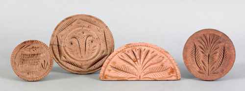 Appraisal: Four Pennsylvania carved butterprints th c one half round with