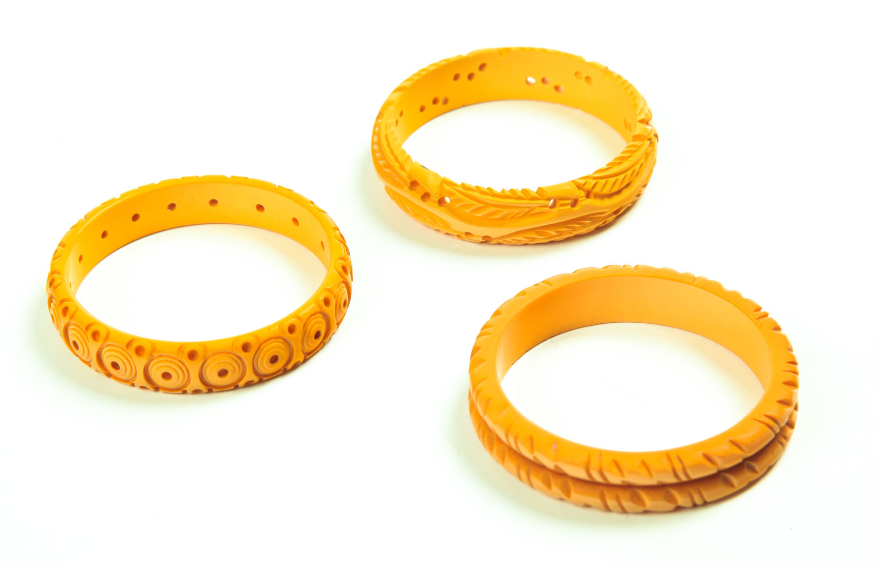 Appraisal: THREE YELLOW BAKELITE BRACELETS American st half- th century Saturn