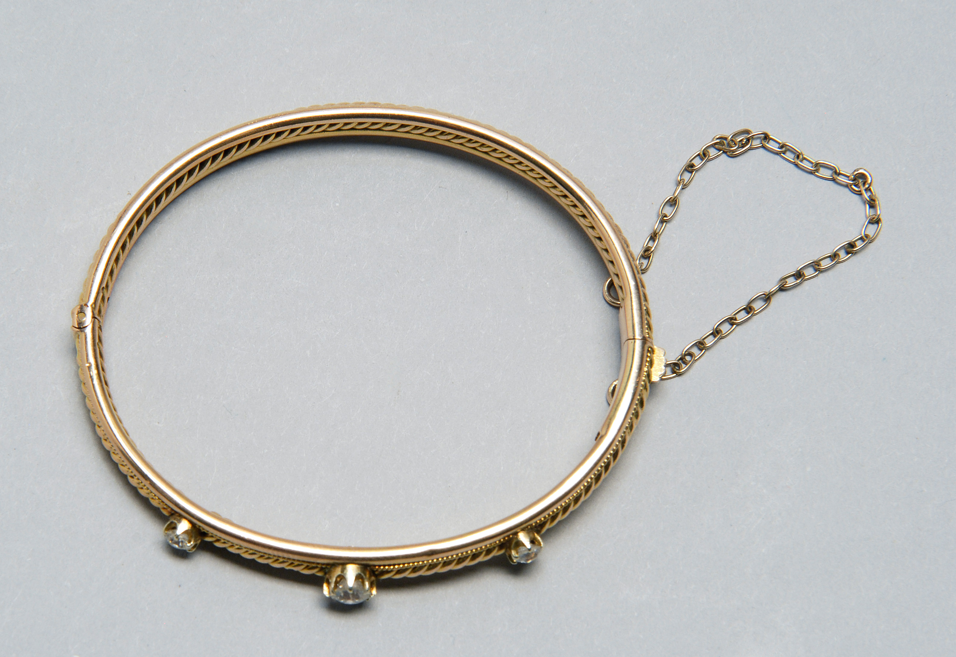 Appraisal: KT GOLD AND DIAMOND BANGLE BRACELET Mid- th CenturyHinged with