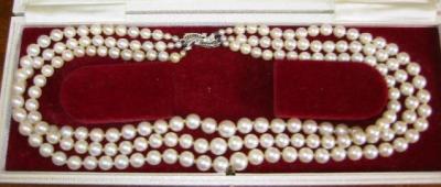 Appraisal: A CULTURED PEARL NECKLACE comprising three strands of graduated pearls