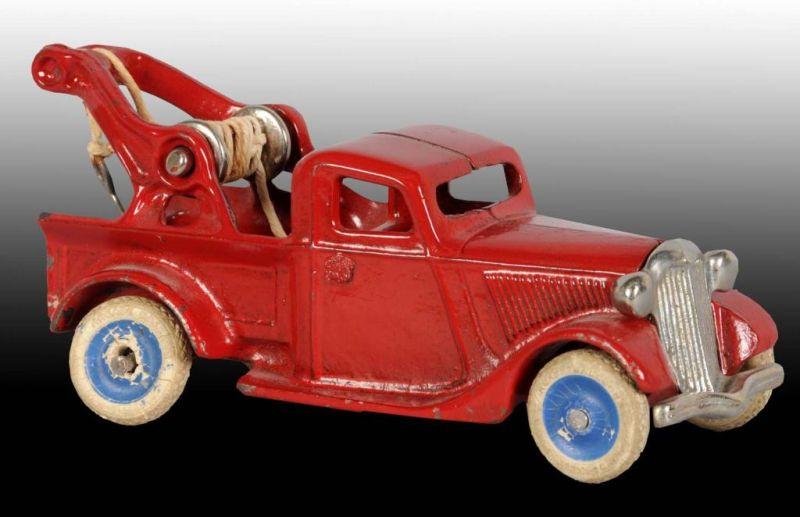 Appraisal: Cast Iron Tow Truck Toy Description Rear wheel has fallen