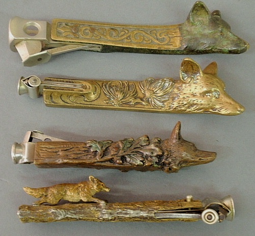 Appraisal: - Four fox form brass bronze cigarillo cutters tobacco pushers