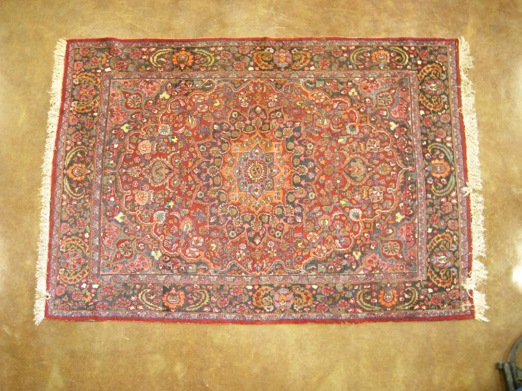 Appraisal: A Persian Carpet of bordered design with central rosette on