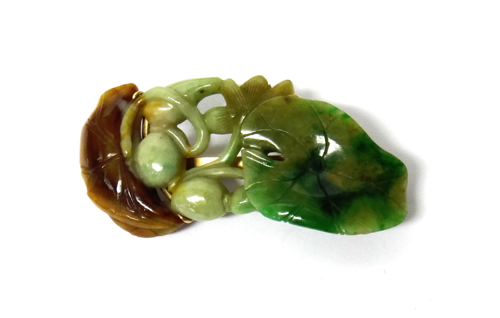 Appraisal: A gold mounted carved green and brown jade brooch designed