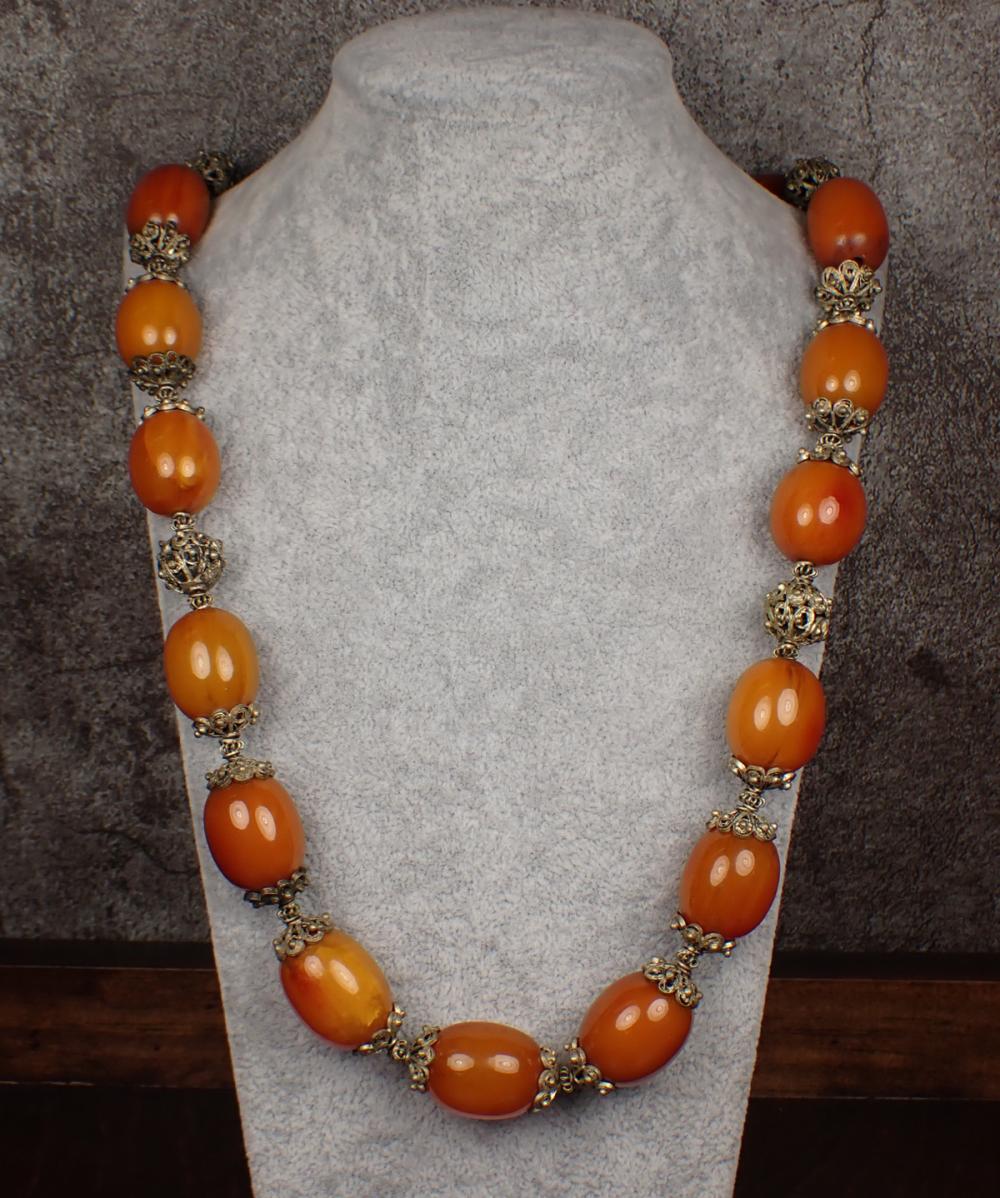 Appraisal: BALTIC AMBER AND FILIGREE BEAD NECKLACE The strand with Baltic