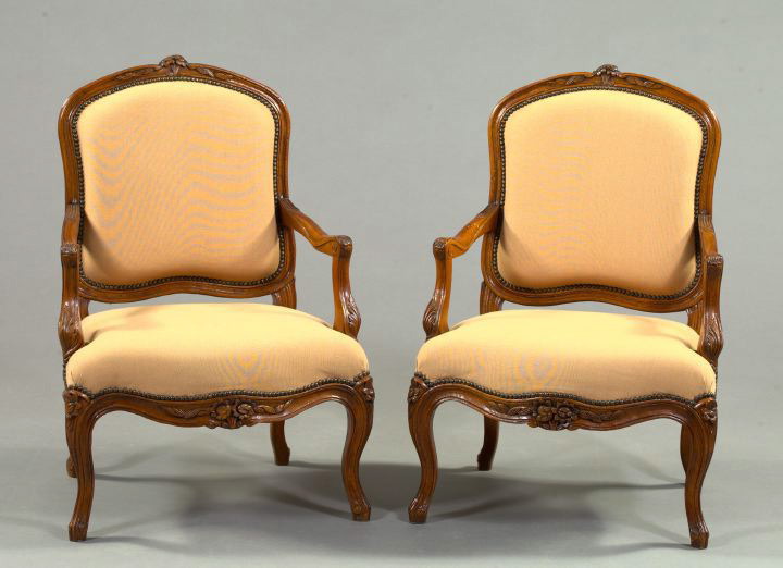 Appraisal: Pair of French Provincial Fruitwood Fauteuils in the Louis XV