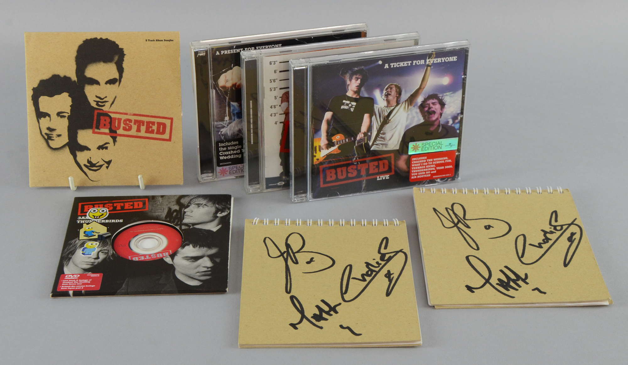 Appraisal: Busted English Pop Band two promotional notepads signed by the