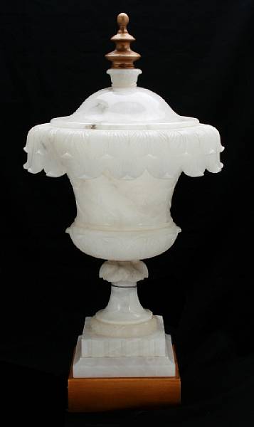 Appraisal: A carved alabaster covered urn mounted on lighted stand height