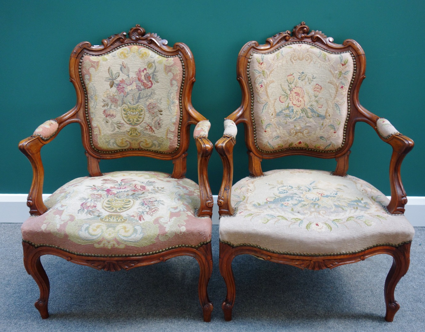 Appraisal: A pair of Louis XV style stained beech open arm