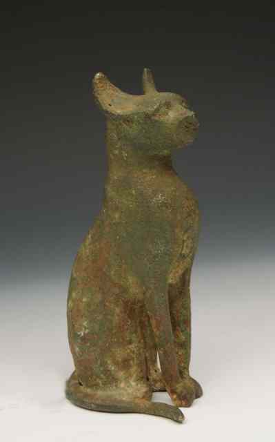 Appraisal: AN EGYPTIAN BRONZE STATUETTE in the form of a cat