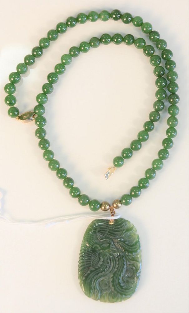 Appraisal: Green jade bead necklace with carved green jade pendant necklace